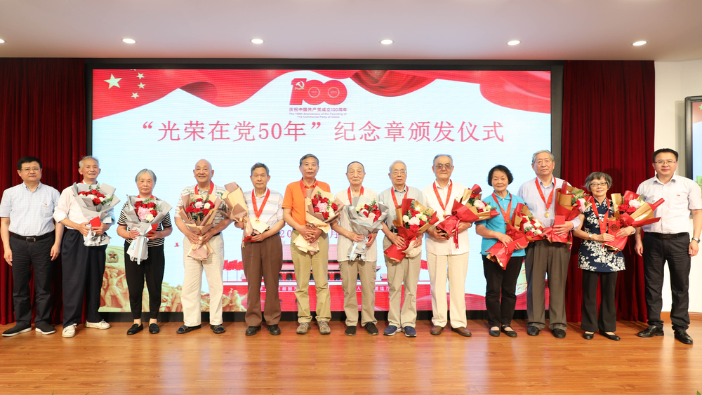 校领导为退休党员颁发纪念章、献花并合影留念